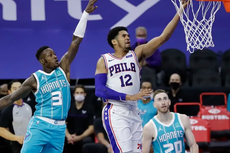 The Sixers' Tobias Harris goes in for a layup past Charlotte's Terry Rozier (left) as Gordon Hayward looks on in the fourth quarter. Harris has played extremely well since a poor outing on opening night.