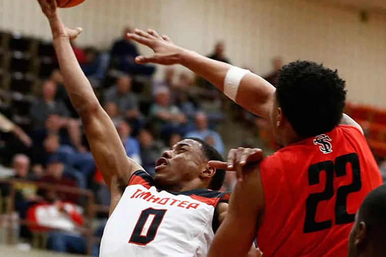 Imhotep's Jaekwon Carlyle drives past Susquehanna defender Quintin Ward in the first half. Carlyle scored 14 points in the win. (Rich Schultz/For The Inquirer)