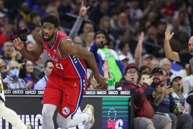 Sixers center Joel Embiid (21) runs down the floor after hitting a three-pointer in the third quarter of a game against the Indiana Pacers at the Wells Fargo Center on Saturday. Sixers won, 133-120.