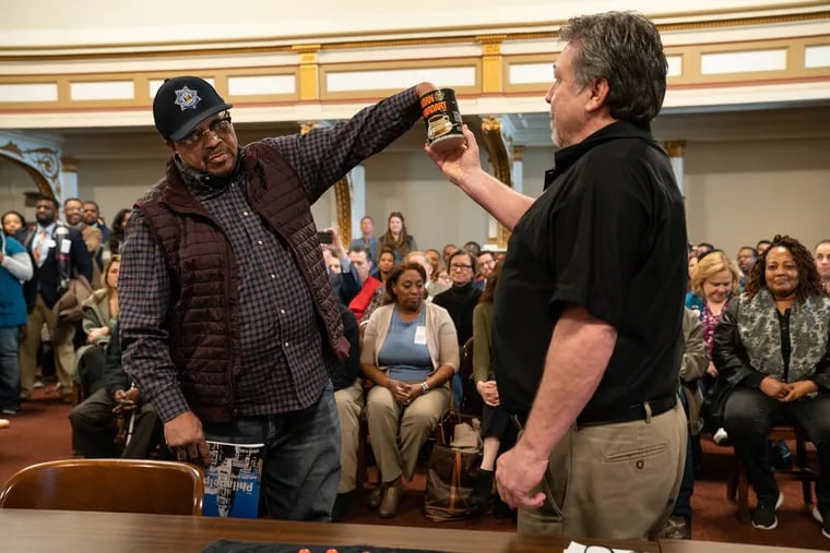 Jewell Williams (left) draws for ballot position out of the coffee can in room 676 of City Hall, in Philadelphia, Wednesday March 20, 2019, with Kevin Kelly, acting supervisor of elections.