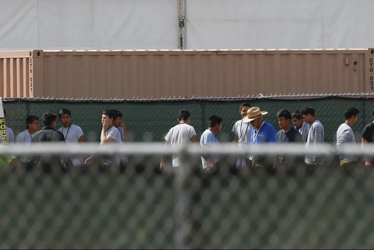 Migrant children walk outside at the Homestead Temporary Shelter for Unaccompanied Children a former Job Corps site that now houses them, on Friday, June 22, 2018, in Homestead, Fla.