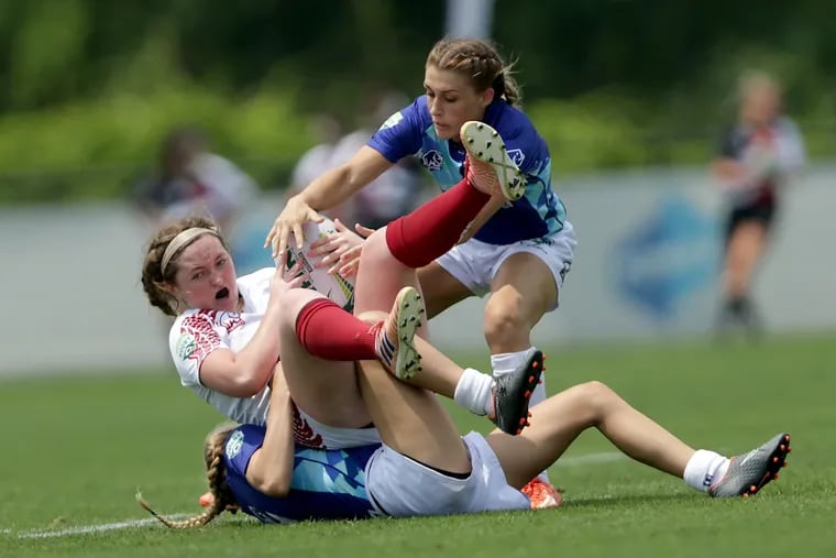 Temple's Emily Woods is tackled by NSCRO's Cecilia Hammond (bottom) and Kelcey Stutzman. 