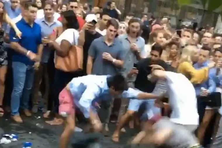 A fight that broke out during Center City SIPS on July 26, 2017, attracted a crowd of onlookers.