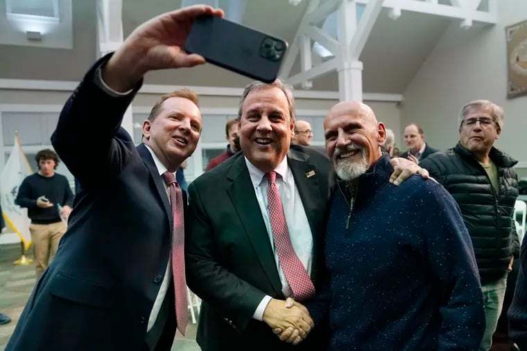Former New Jersey Gov. Chris Christie (center) poses for a selfie after a town hall-style meeting at New England College on April 20 in Henniker, N.H. He's expected to officially launch his campaign on Tuesday.