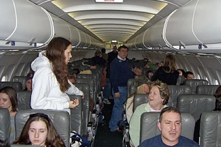 In this 2007 file photo, stranded passengers aboard a JetBlue flight while wait hours to take off at John F. Kennedy International Airport in New York. (AP Photo/Lou Martins, File)