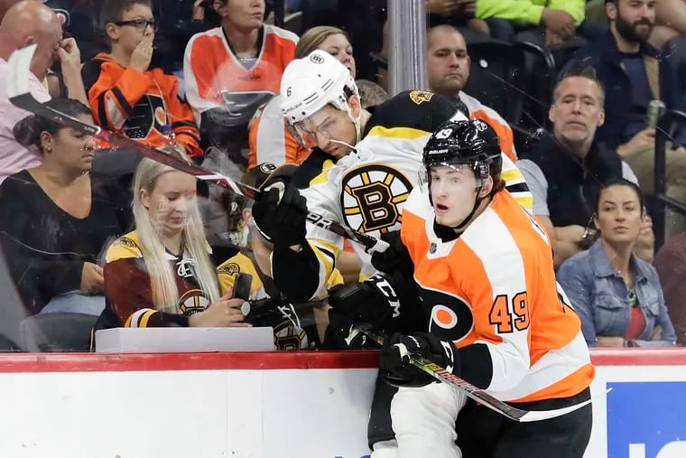 Flyers right winger Joel Farabee checks Boston Bruins defenseman Alex Petrovic in a recent preseason game.