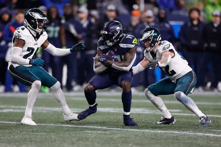 Eagles safety Reed Blankenship (right) and cornerback James Bradberry go after Seattle Seahawks wide receiver DK Metcalf at Lumen Field in Seattle on Monday, December 18, 2023.