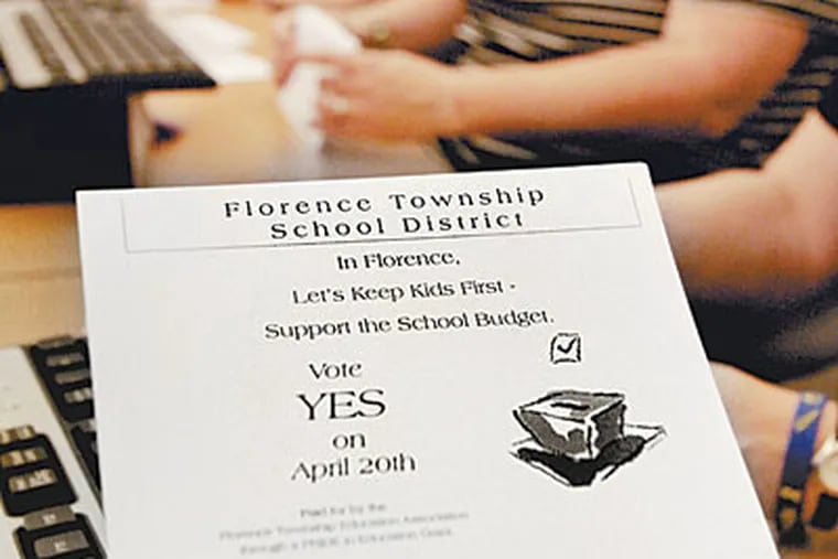 Florence High teachers stuff envelopes with letters urging support for the district budget. (ELIZABETH ROBERTSON/Staff Photographer)