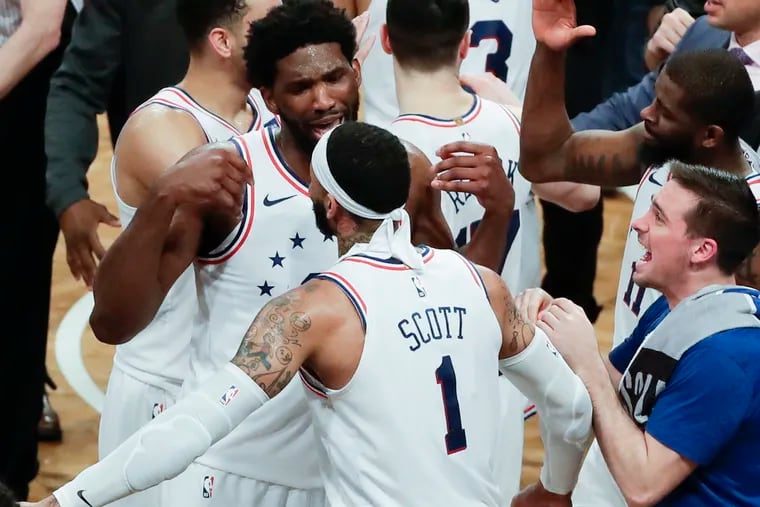 Sixers forward Mike Scott celebrates with teammate center Joel Embiid after the Sixers beat the Brooklyn Nets in game four of the Eastern Conference playoffs on Saturday, April 20, 2019 in Brooklyn.