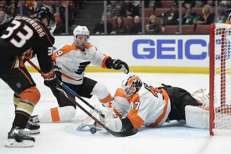 Flyers goaltender Brian Elliott stops a shot Tuesday by Anaheim's Jakob Silfverberg as defenseman Ivan Provorov helps out.. The Flyers won, 3-2.