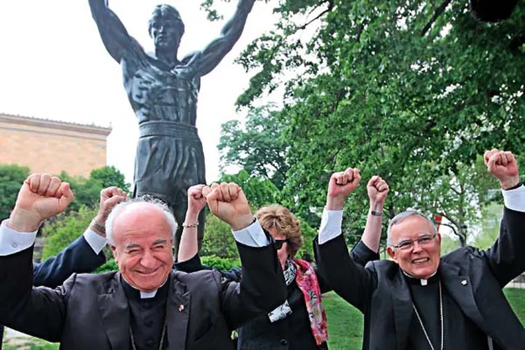 Archbishop Vincenzio Paglia, left, from the Vatican, strikes a very Philadelphia pose in front of the Rocky statue along with Archbishop Charles Chaput, right, and First Lady of Pennsylvania, Susan Corbett, background, on Tuesday during the tour of the city. ( AP PHOTO / The Philadelphia Inquirer / Michael Bryant )