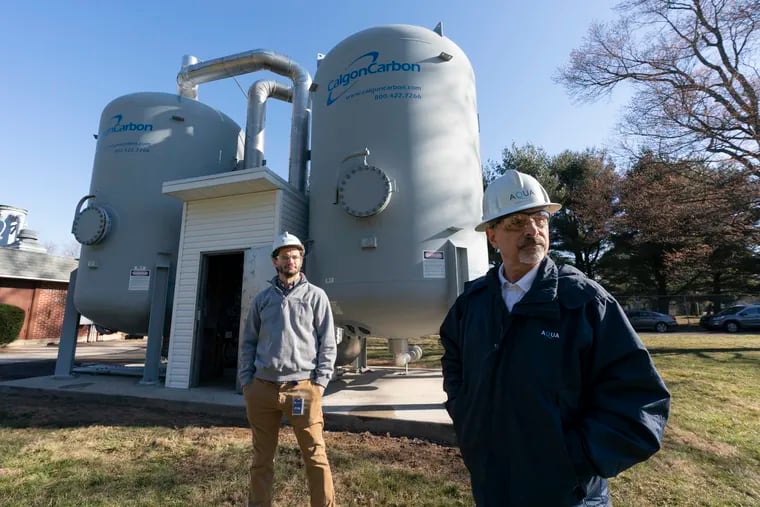 Dave Rustay (left), treatment manager at Aqua America, and Marc Lucca, president of Aqua Pennsylvania, in front of the new Granular Activated Carbon Pressure Vessels at the company's New Britain plant.