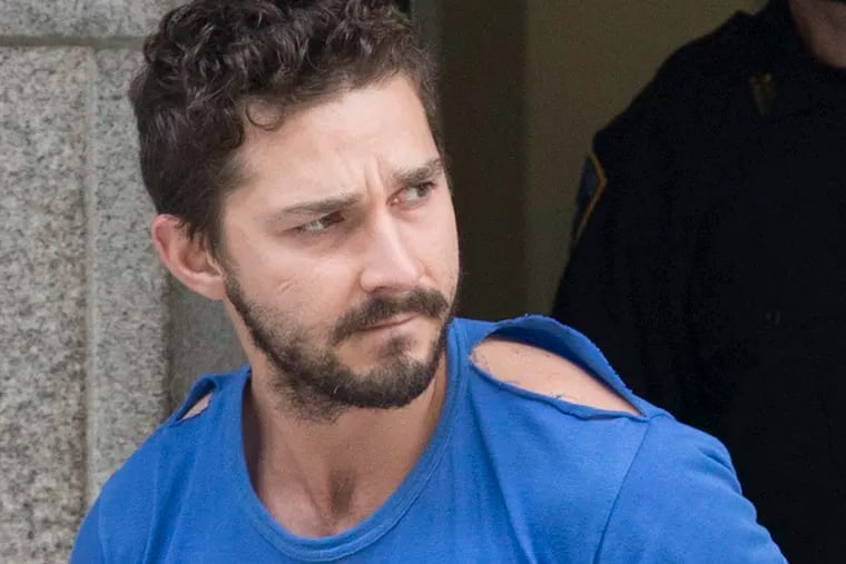 Actor Shia LaBeouf leaves Midtown Community Court after being arrested the previous day for yelling obscenities at the Broadway show "Cabaret," Friday, June 27, 2014, in New York. The 28-year-old star of the "Transformers" franchise faces charges that include disorderly conduct and criminal trespass.  (AP Photo/John Minchillo)