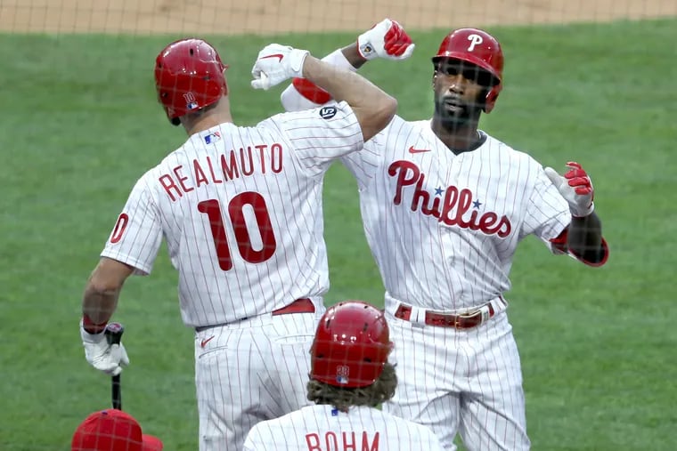 Andrew McCutchen, right, hit two home runs Tuesday night in the Phillies' 6-5 victory over the Milwaukee Brewers at Citizens Bank Park.