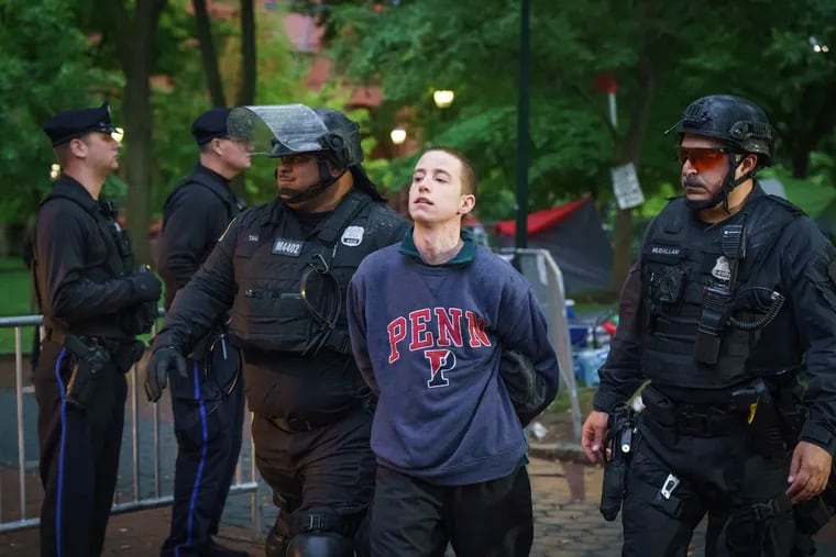 Police detain a protesters at the University of Pennsylvania campus, on Friday.