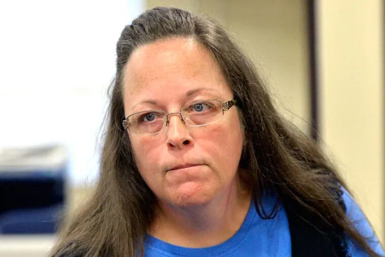 Rowan County Clerk Kim Davis listens to a customer following her office's refusal to issue marriage licenses at the Rowan County Courthouse in Morehead, Ky., Tuesday, Sept. 1, 2015. (AP Photo/Timothy D. Easley)