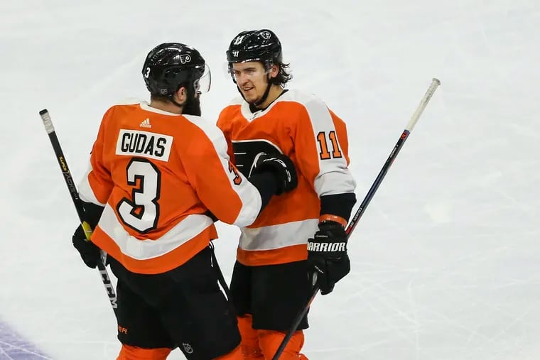 Travis Konecny (right) and Radko Gudas celebrate a goal against the Red Wings earlier this month.
