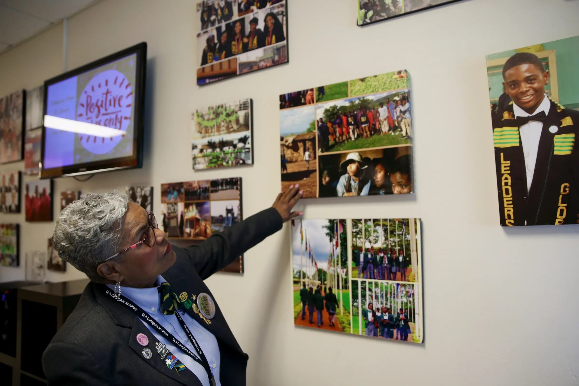 CEO and founder Naomi Johnson-Booker looks at pictures of student trips abroad that hang at Global Leadership Academy Charter School.
