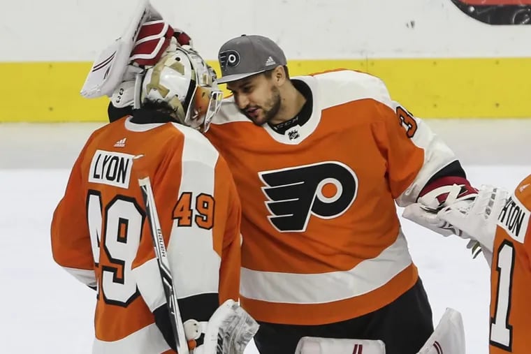 New Flyers goalie Petr Mrazek (right) celebrates with rookie goalie Alex Lyon after the overtime victory over the Canadiens.