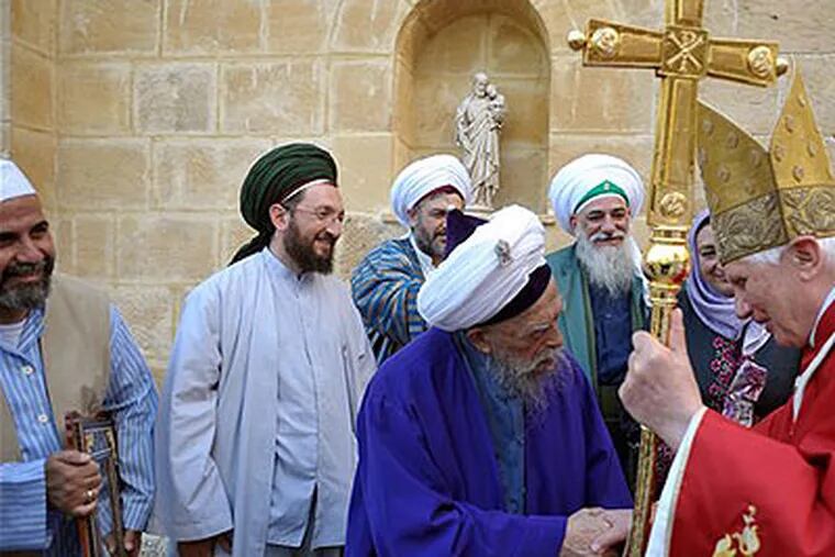 Sufi mystic Sheikh Nazim, next to other Muslim clergymen, shakes hands with Pope Benedict XVI before the mass led by the pontiff at the church of the Holy Cross at the compound of the Franciscan convent of Holy Cross, in Nicosia, Cyprus, last Saturday. (AP Photo / Osservatorio Romano, HO)