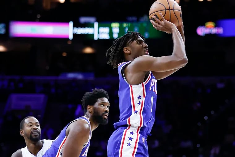 Sixers guard Tyrese Maxey shoots the basketball against the Orlando Magic while reading a pick Joel Embiid.