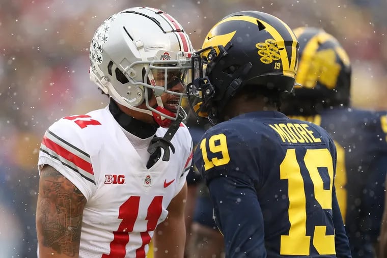Ohio State wide receiver Jaxon Smith-Njigba (left) and Michigan defensive back Rod Moore (right) butt helmets during last year's game. Michigan travels to Ohio State on Saturday in a matchup of two of college football's remaining four undefeated teams. (Photo by Mike Mulholland/Getty Images)