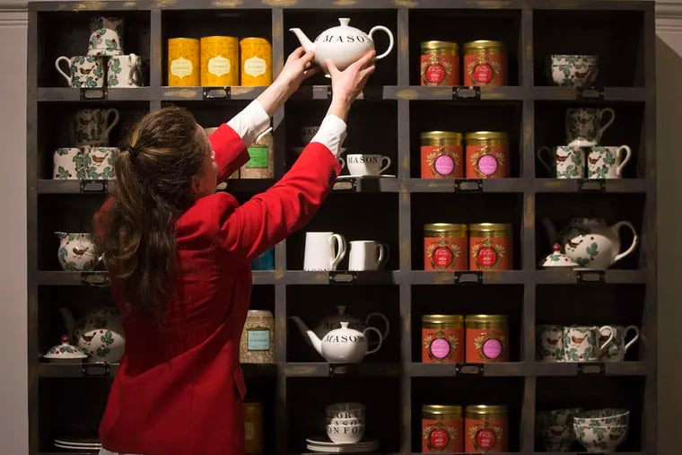 An employee places a teapot onto a specialty tea display shelf inside a pop-up store operated by Fortnum & Mason Plc during a seasonal event at Somerset House in London. The British will be the biggest spenders in Europe on Christmas gifts this year, according to a study commissioned by Dutch bank ING Groep NV.
