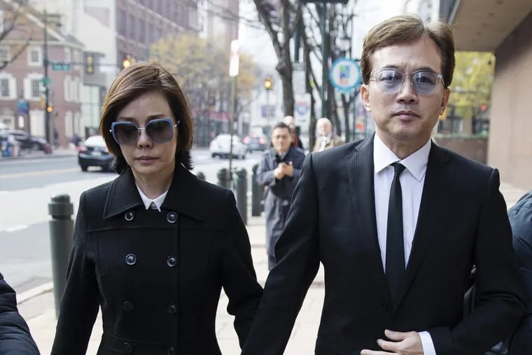 Sun Peng, center right, and Di Ying walk from the federal courthouse in Philadelphia on Monday, after their son An-Tso Sun, a Taiwanese exchange student accused of threatening to "shoot up" his high school near Philadelphia has been spared additional time in prison.