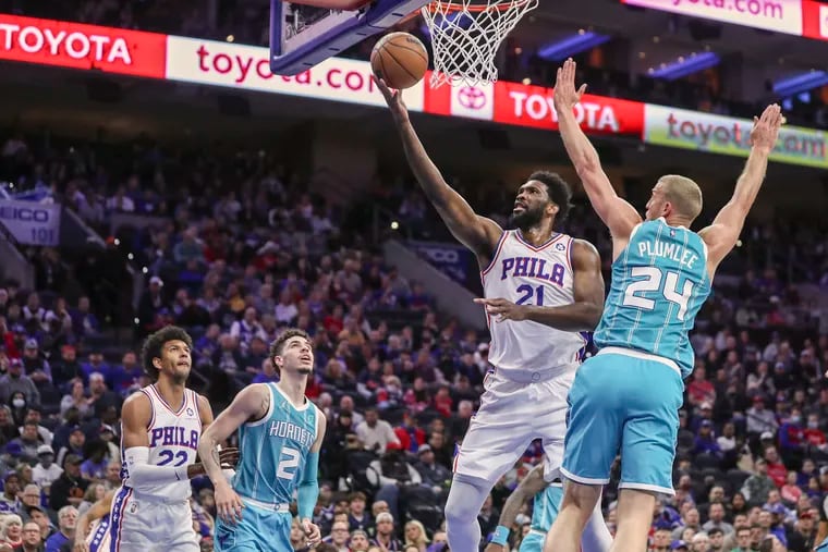 Philadelphia 76ers center Joel Embiid (21) scores past Charlotte Hornets center Mason Plumlee (24) in the first half of a game at the Wells Fargo Center in Philadelphia on Saturday, April 2, 2022.