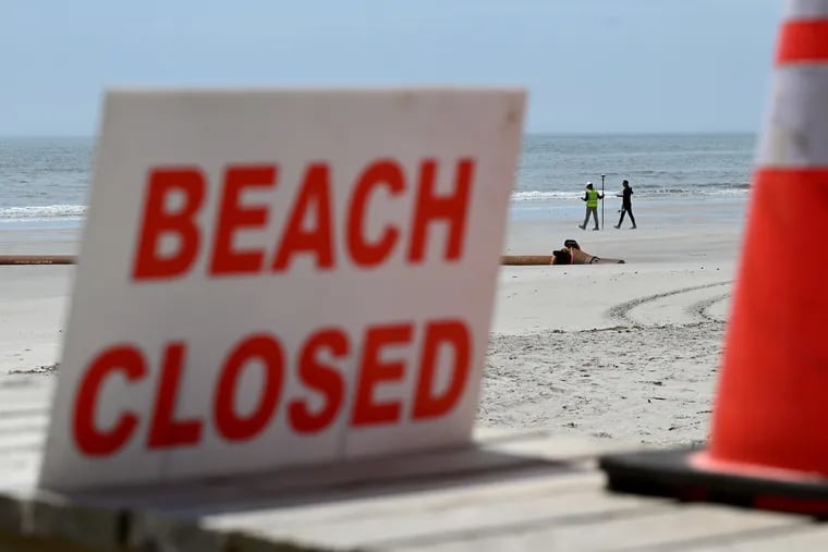 A dredge pipe and surveyors were on the closed beach near Seventh Street in North Wildwood on Monday. Crews are expected to begin this week pumping sand to replenish the city’s badly eroded beaches. The deal for the emergency dredging project is the result of a dispute between Mayor Patrick Rosenello and the state's Department of Environmental Protection.