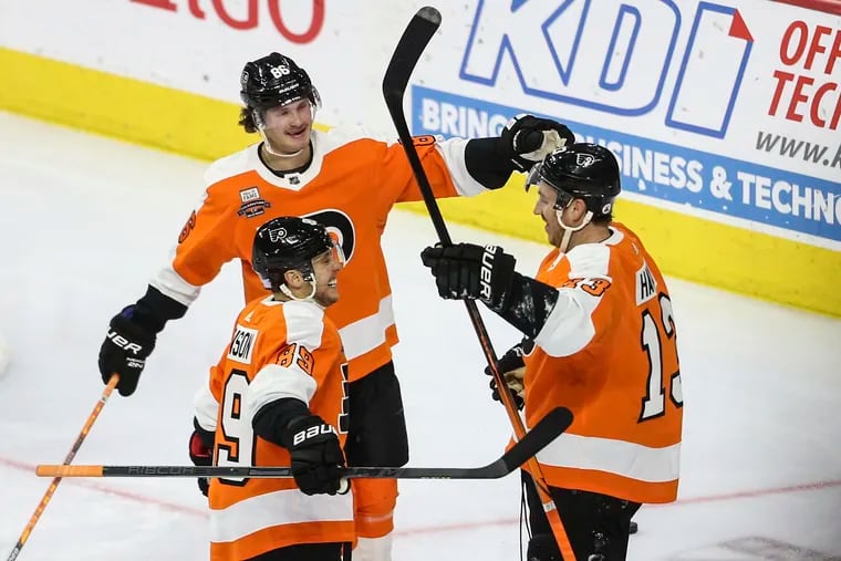 Flyers Kevin Hayes right celebrates his goal against the Flames with teammates Joel Farabee 86 and Cam Atkinson during the second period at the Wells Fargo Center in Philadelphia, Tuesday, November 16 2021.