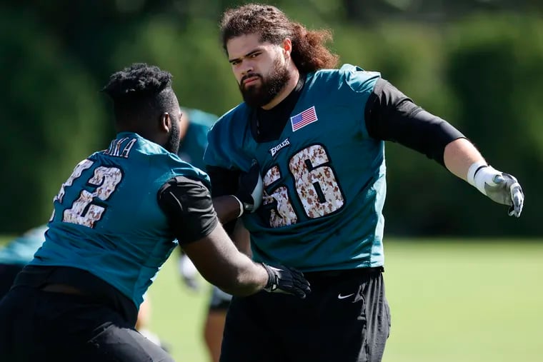 Eagles guard Isaac Seumalo (right) warms-up with teammate guard Kayode Awosika during training camp at the NovaCare Complex on Saturday, July 30, 2022.