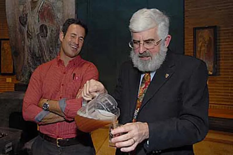 Penn researcher Patrick McGovern pours a glass of Chicha, a collaboration with Sam Calagione (left) of Dogfish Head brewing. (Bob Williams / For The Inquirer)