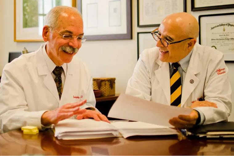 Howard Weitz (left) and Geno Merli joke during work at Thomas Jefferson University Hospital. They film an innovative medical education show called "The Consult Guys."