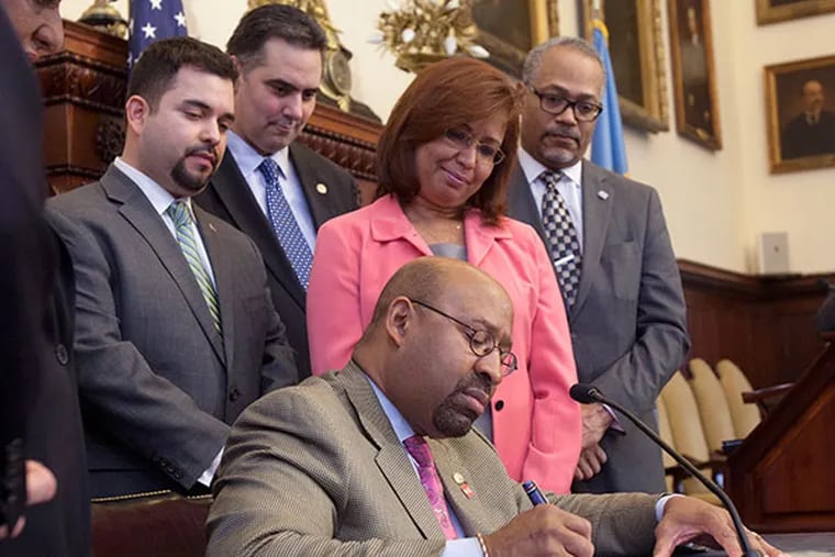 (Left to right) Fernando Trevino, Mayors Office of Immigration, Rich Negrin, Managing Director, Councilwoman Maria Quinones Sanchez and the Mayors Chief of Staff Everett Gillison watch as Mayor Michael Nutter signs an executive order ending so-called ICE holds, non-mandatory deportation in Philadelphia on Wednesday, April 16, 2014. ( ED HILLE / Staff Photographer )
