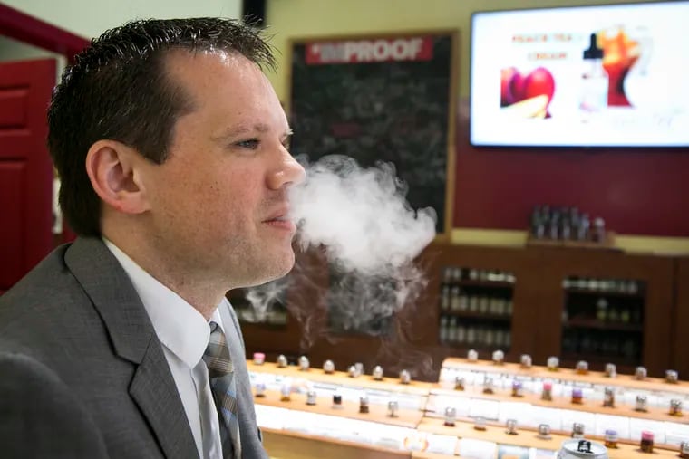 Greg Conley, a South Jersey lawyer and vaping advocate, enjoys a puff at Firehouse E-cigs and Vapors, in Cherry Hill.