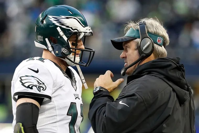 Doug Pederson (right) expects Carson Wentz (left) to be ready to participate in organized team activities.