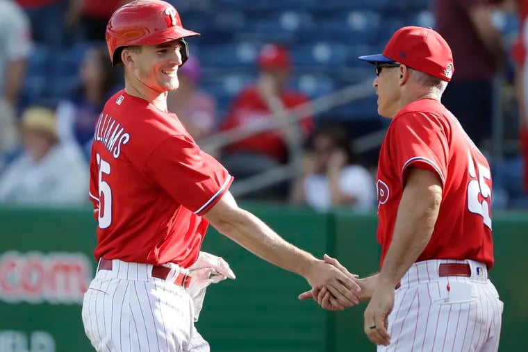 Luke Williams (left) has played anywhere and everywhere in the minors, and his performance hasn't gone unnoticed by Phillies manager Joe Girardi (right).