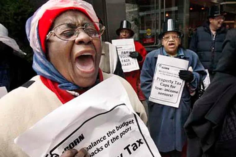 Evelyn Gibson of South Phila. (left) expresses her tax abatement displeasure along with other ACORN members during a protest at The Residences at Two Liberty Place on Wednesday.  (Elizabeth Robertson / Staff Photographer)