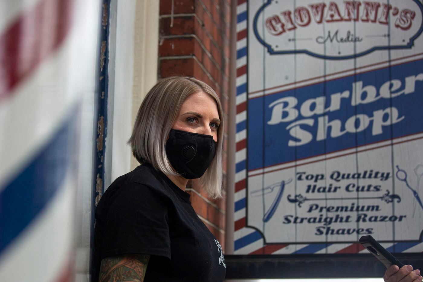 Nichole Missino, owner of Giovanni’s Media Barber Shop, speaks to a reporter at the doorstep of her barber shop on Wednesday, May 20, 2020. 