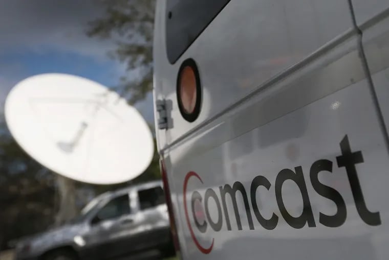 A Comcast truck parked at one of the system's headends, the hubs from which broadband internet and cable service is distributed to customers. Comcast on Monday pledged to double its network energy efficiency by 2030.