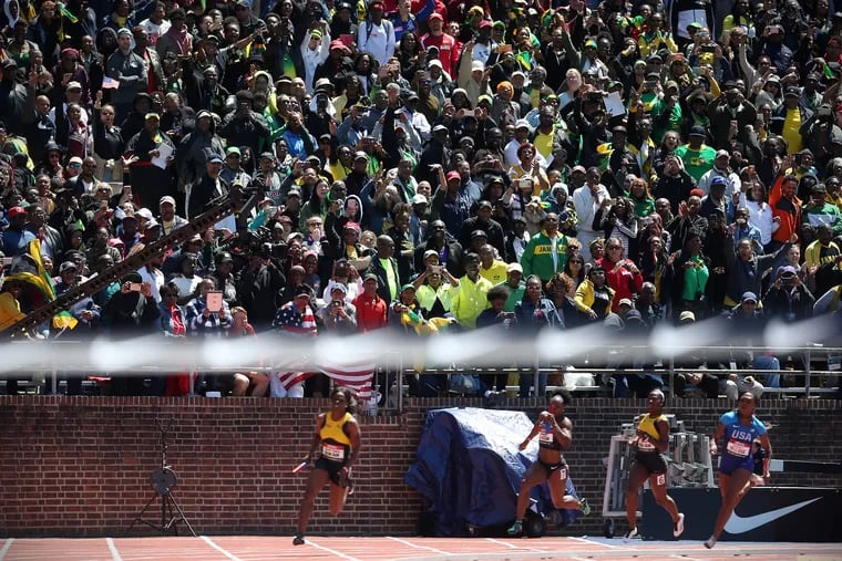 Fans cheer as Jamaica's Schillonie Calvert leads on the final turn of the USA vs. the World women's 4x100 during the 125th annual Penn Relays on April 27, 2019. Jamaica won the event.