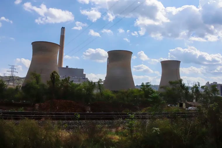 The Bruce Mansfield power plant in Shippingport, Pa., is seen across the Ohio River from Industry, Pa.. Owners of coal-fired power plants could pay more to emit carbon dioxide under Gov. Tom Wolf's plan announced Thursday.