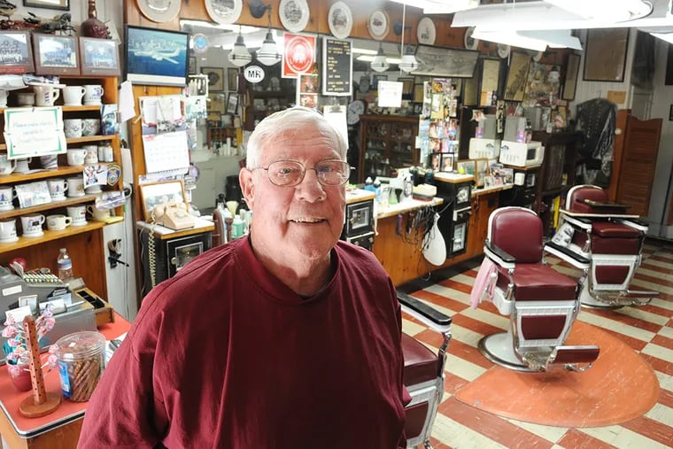 Don Thompson at his barbershop in Mount Holly, where even the cash register goes back to simpler times. (CLEM MURRAY / STAFF PHOTOGRAPHER)