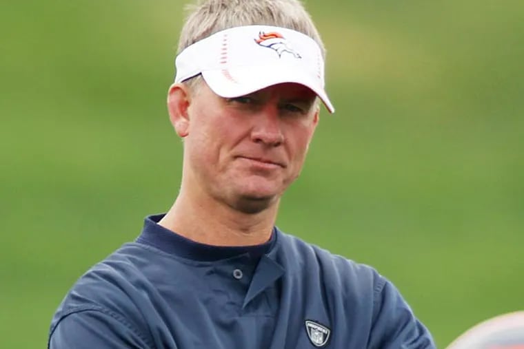 Denver Broncos offensive coordinator Mike McCoy, front, looks on during drills at the Broncos' NFL football rookie minicamp at the team's training headquarters in Englewood, Colo., on Saturday, May 12, 2012. (AP Photo/David Zalubowski)