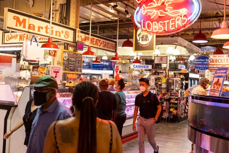 People walk and shop through Reading Terminal Market in Center City on Aug., 11, 2021.