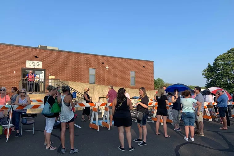 Community members wait to enter the Central Bucks School Board meeting Wednesday night. The board voted 5-4 against a mask mandate and other COVID-19 mitigation measures.