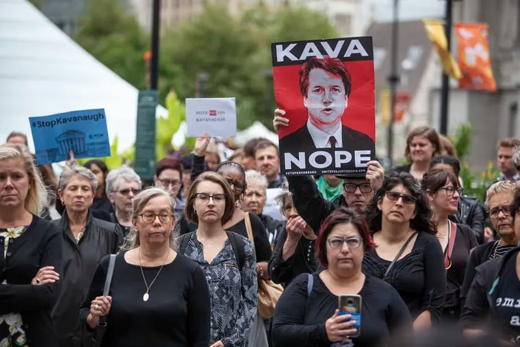 A crowd gathers at Dilworth Plaza by City Hall for a walkout in solidarity with Christine Blasey Ford, who accused Brett Kavanaugh of sexual assault, on Monday, Sept. 24, 2018. Survivors of sexual assault shared their stories with the crowd, and then led a march around City Hall. The walkout is part of a nationwide movement called for by Tarana Burke, the founder of the #MeToo movement.