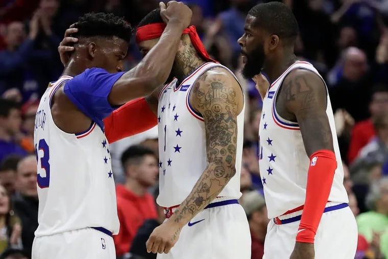 Sixers guard Jimmy Butler celebrates a defensive stop on the Toronto Raptors with teammates Mike Scott (center) and James Ennis III during the third quarter in Game 6 of the Eastern Conference playoff semifinals on Thursday.