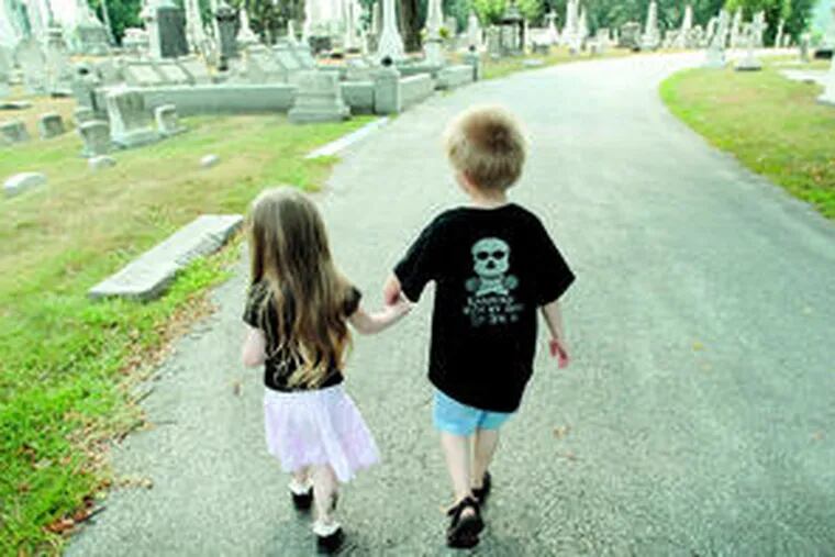So cute you could just die: Faith Eternity Renalli-Del Rosario and Joe Holtzinger stroll hand in hand in Laurel Hill Cemetery. Faith&#0039;s mother organizes social events for a group of Philadelphia-area fun-loving goth parents through Meetup.com, with 73 members, and runs an occasional club dance party called Kinderbats for parents and kids.